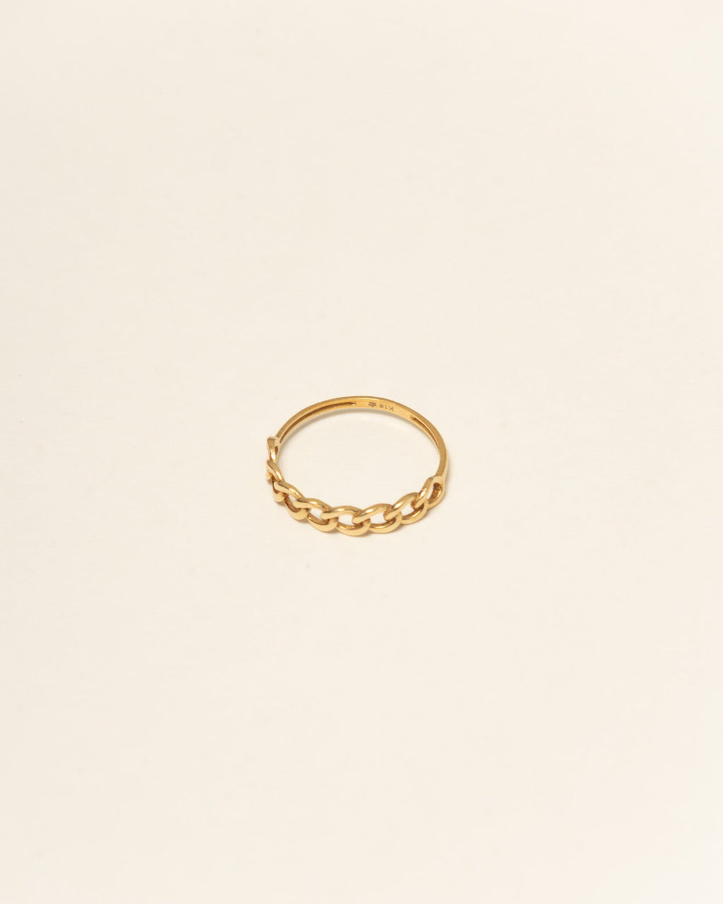 Gold ring on a beige background