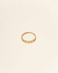 Gold ring on a beige background