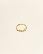 Gold ring on a beige background