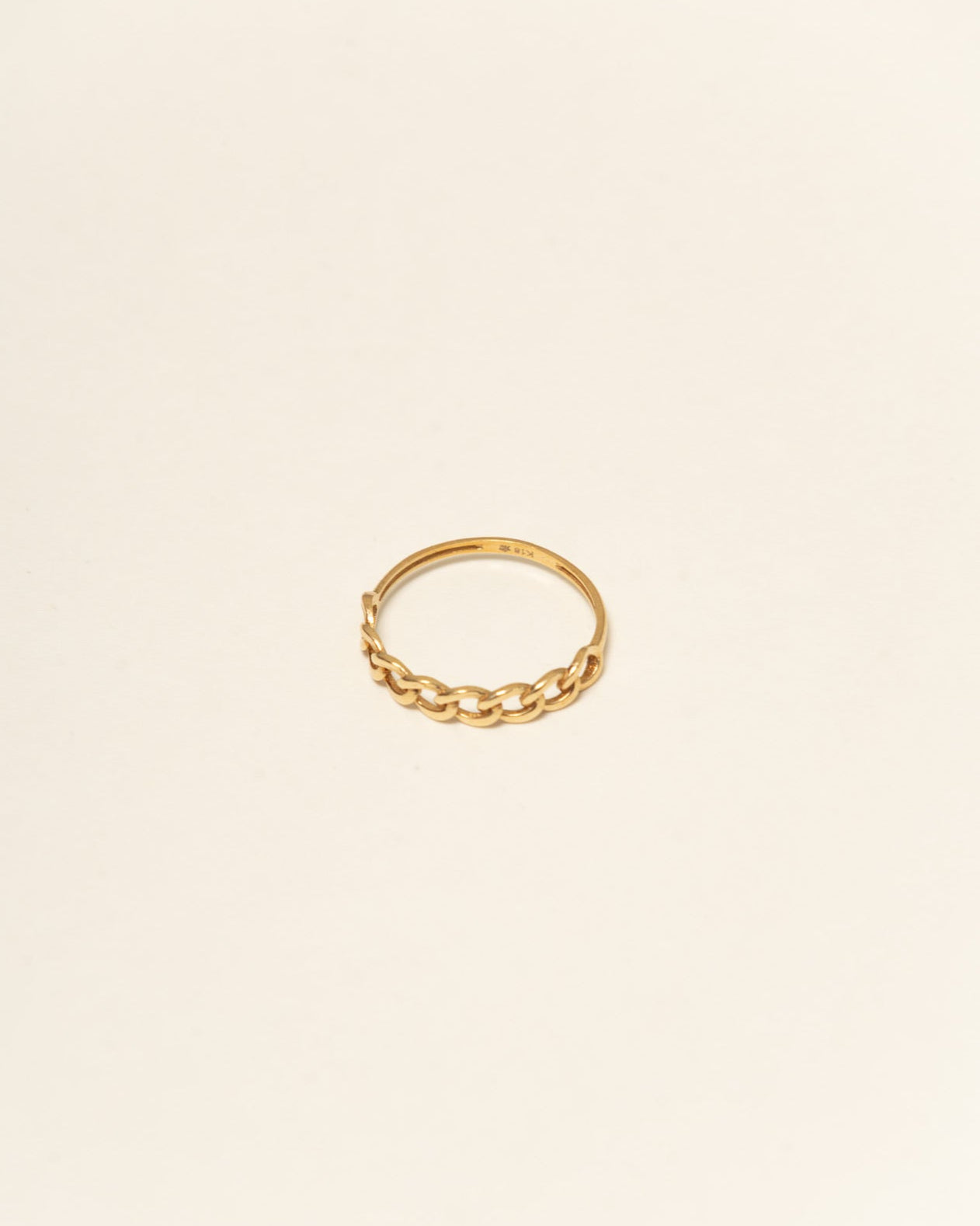 Gold ring on a beige background